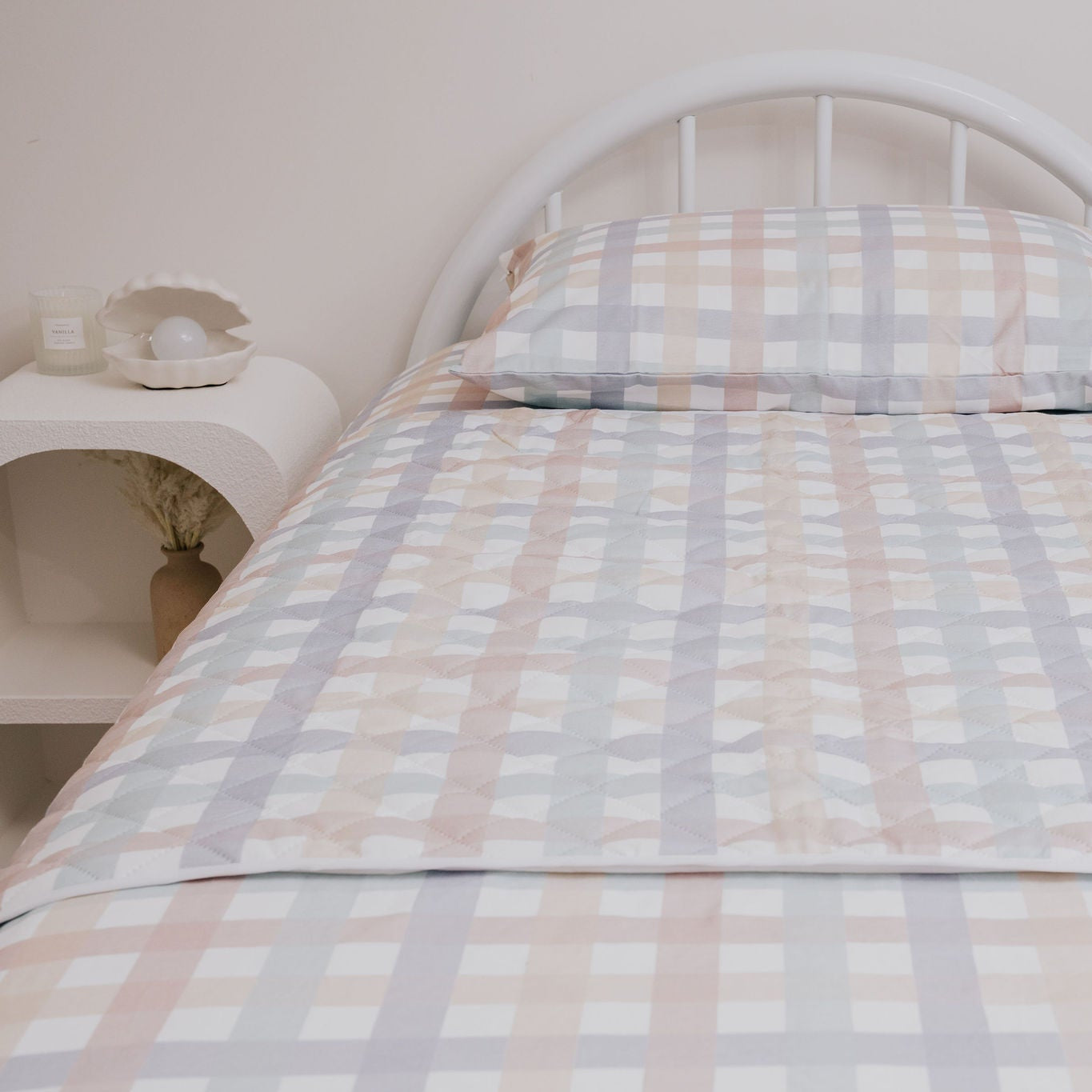 Bed with checkered bedding in a room setting