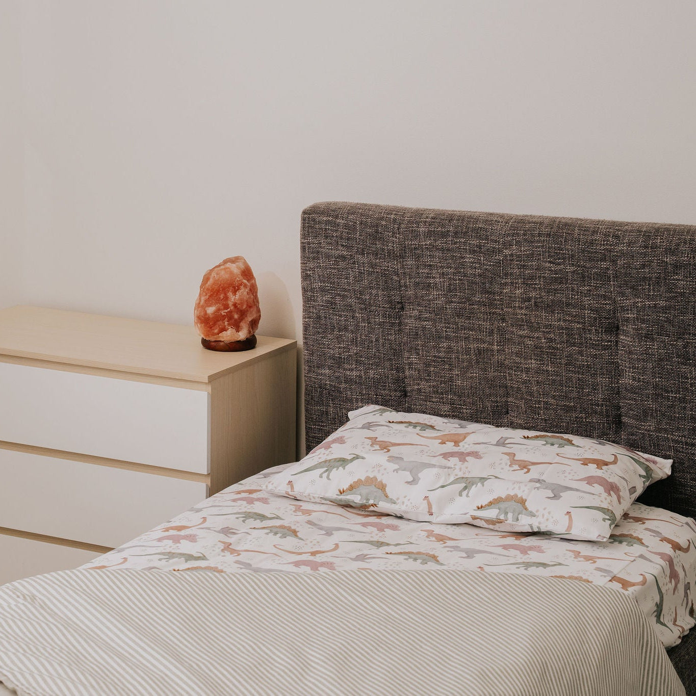 Bedroom with a bed, nightstand, and wall art