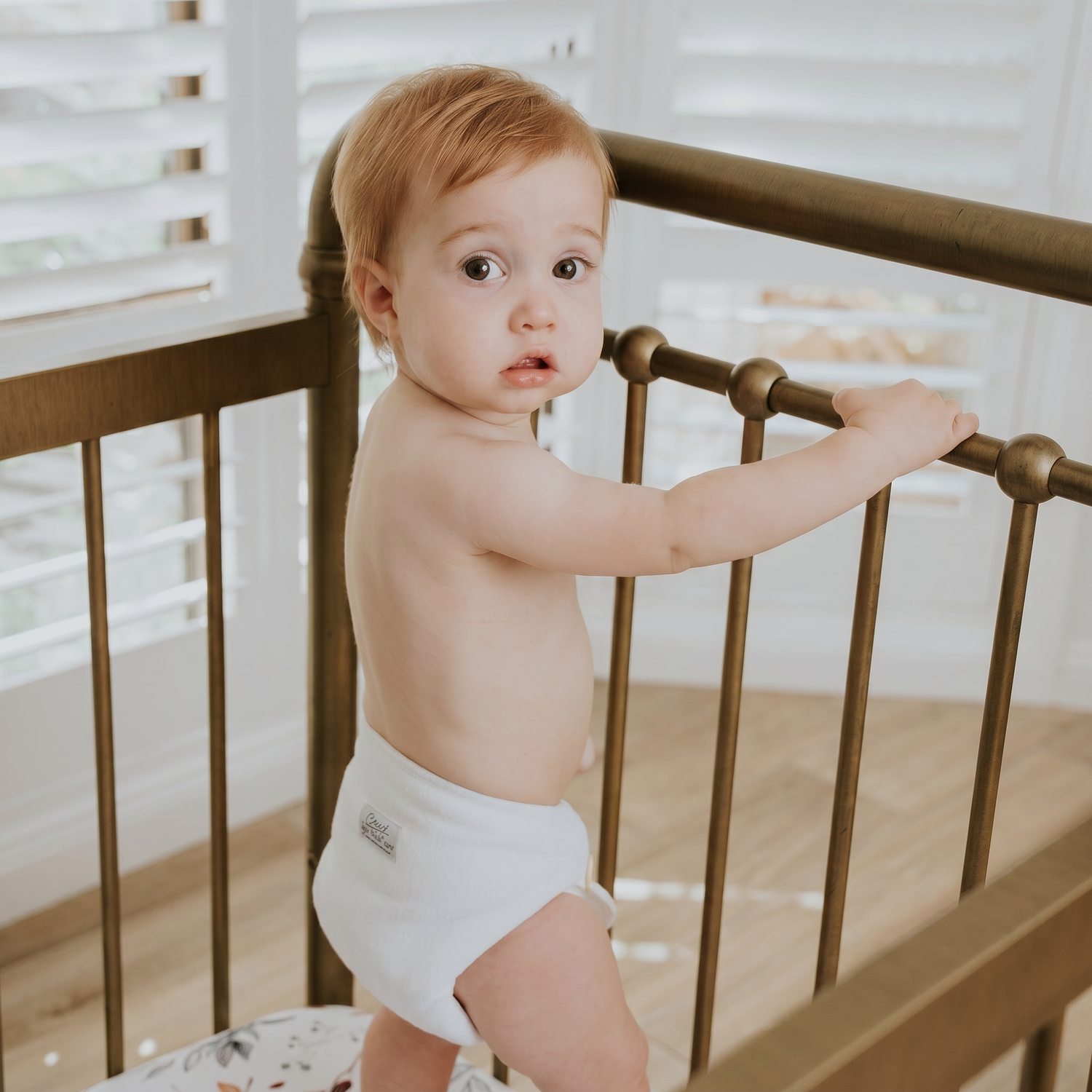 Infant boy wearing a modern cloth nappy preflat
