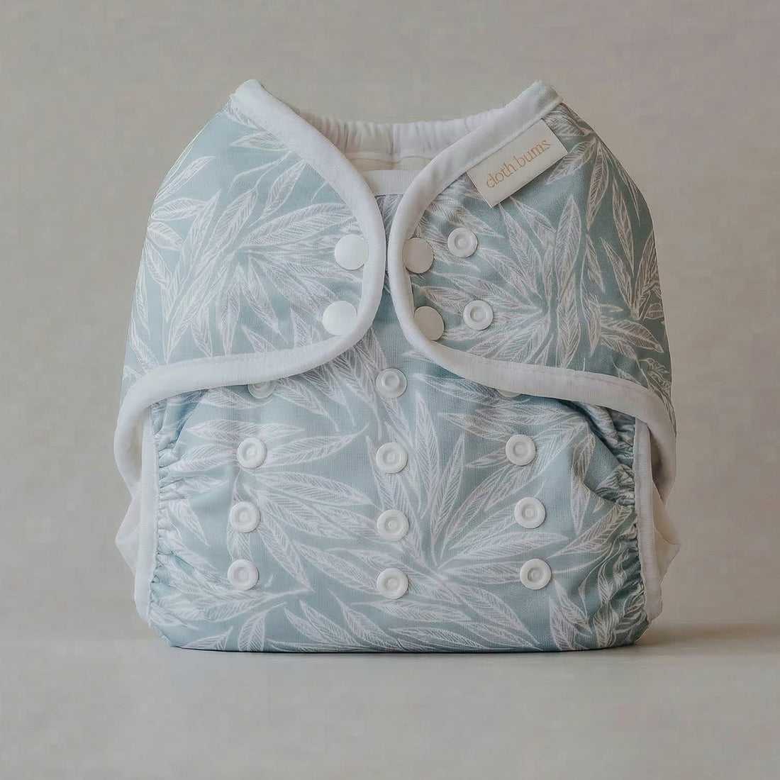 Baby diaper with leaf pattern on a plain background