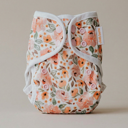 Floral patterned cloth diaper on a neutral background