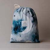 Single bed sheet in a bag with celestial design on a beige background