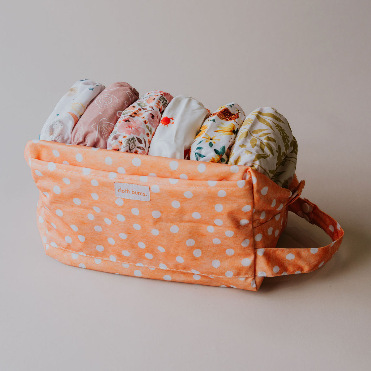 Pod wet bag in Marmalade print, open and filled with cloth nappies