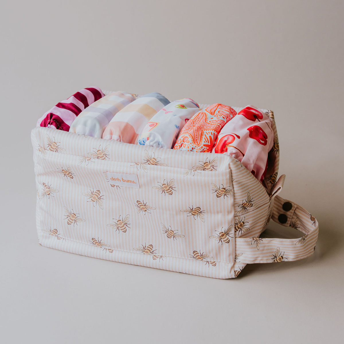 Pod wet bag in Beeline print, open and filled with cloth nappies