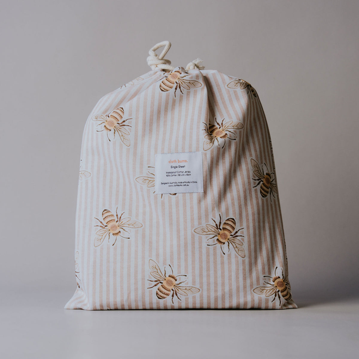Single waterproof fitted sheet in Beeline print, packed in its drawstring bag