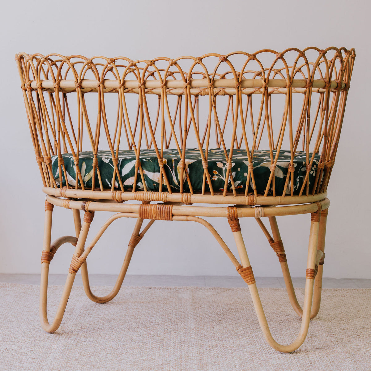 Rattan bassinet made up with an Evergreen waterproof sheet