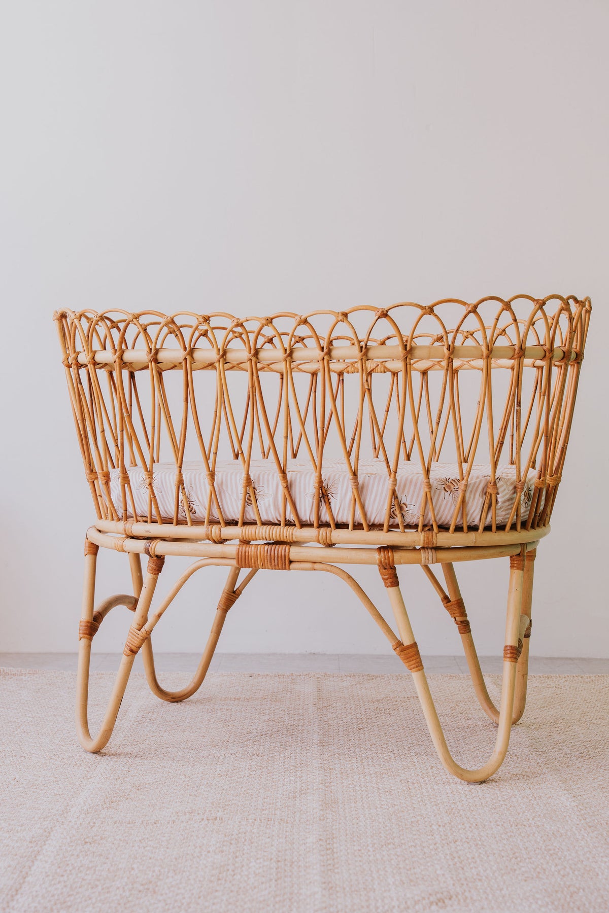 Rattan bassinet made up with a Beeline waterproof sheet