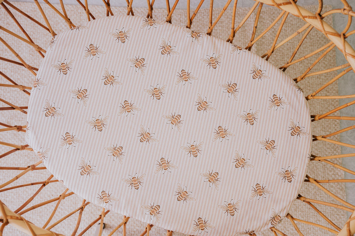 Rattan bassinet fitted with the Beeline waterproof sheet, seen from above