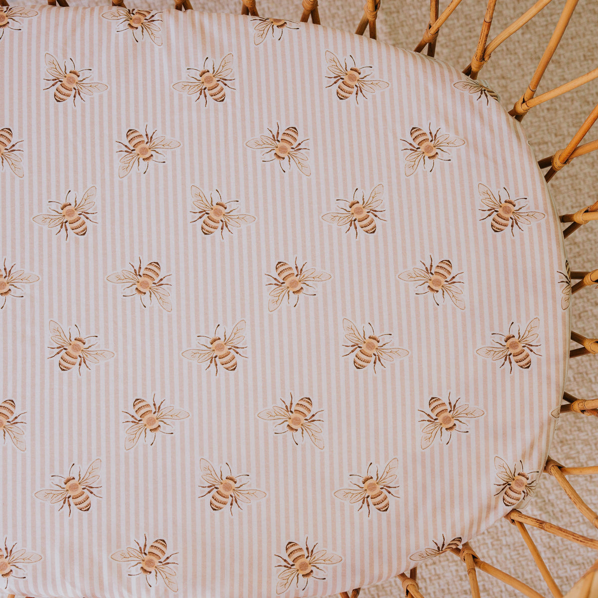 Close-up of the Beeline waterproof sheet in a rattan bassinet