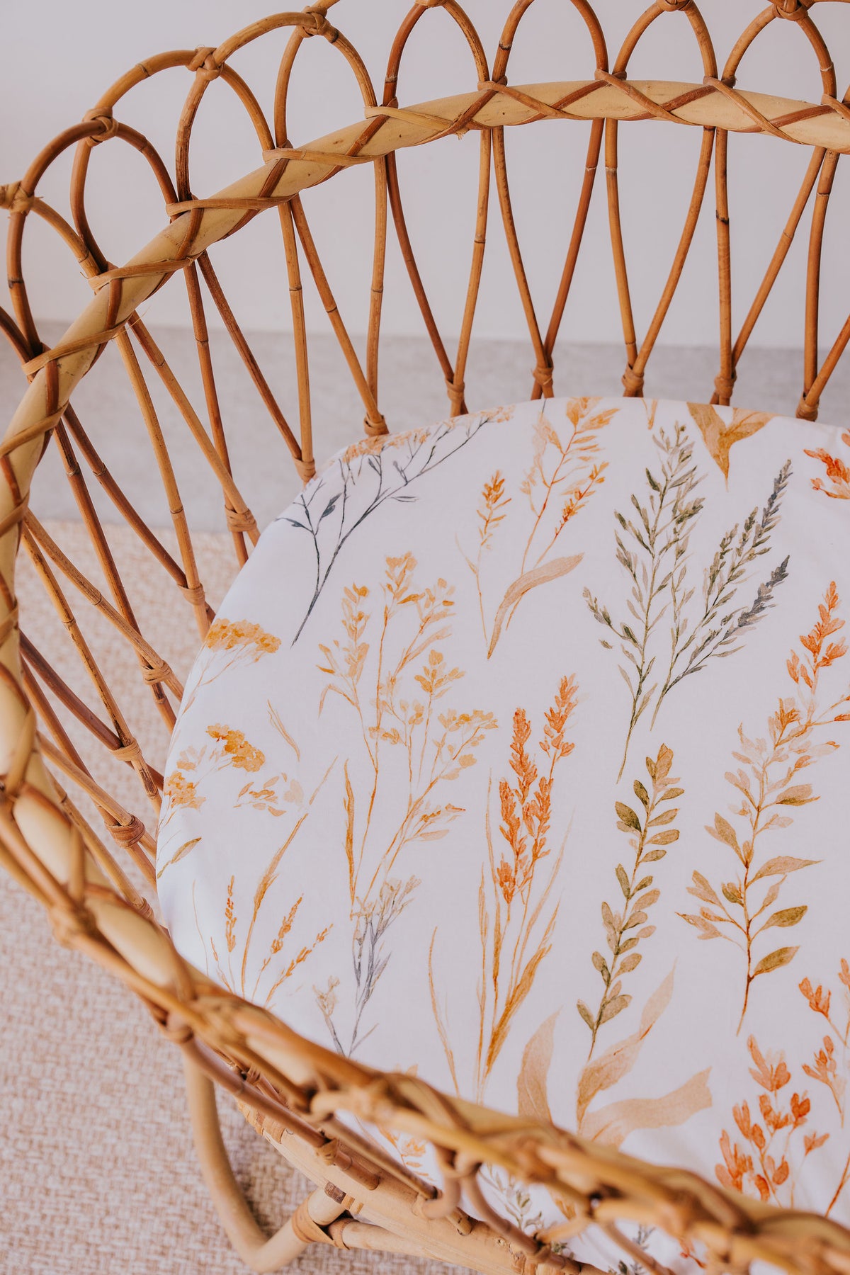 Rattan bassinet made up with a Wild Prairie waterproof sheet