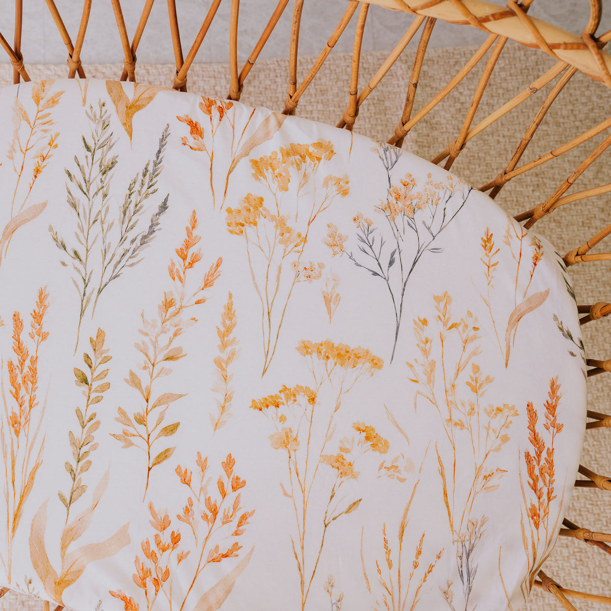 Rattan bassinet fitted with the Wild Prairie waterproof sheet, seen from above