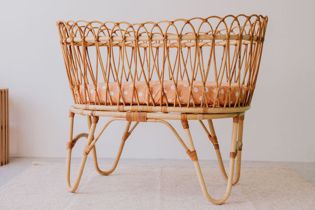 Rattan bassinet made up with a Marmalade waterproof sheet