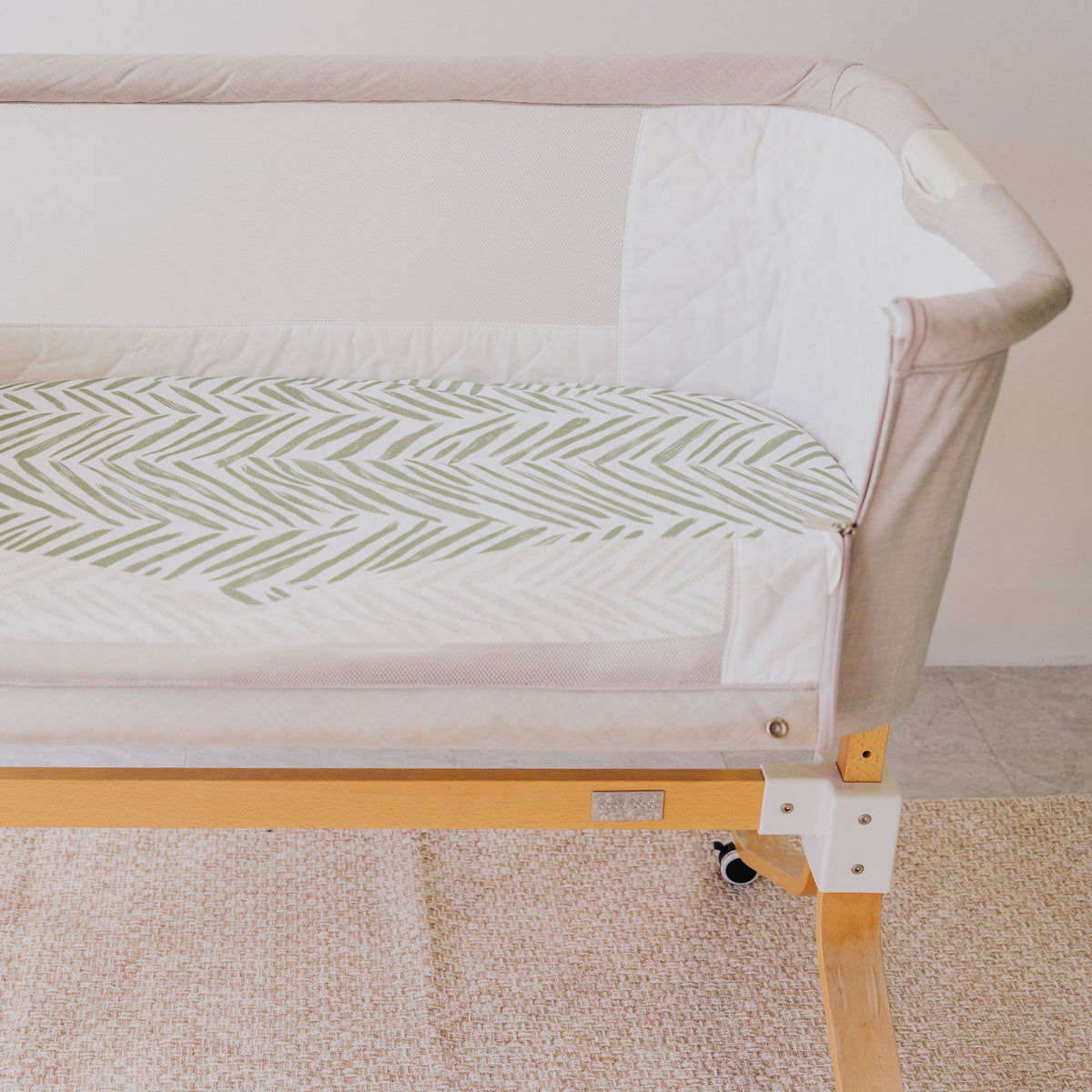 Bedside co-sleeper made up with the Greenhouse waterproof sheet