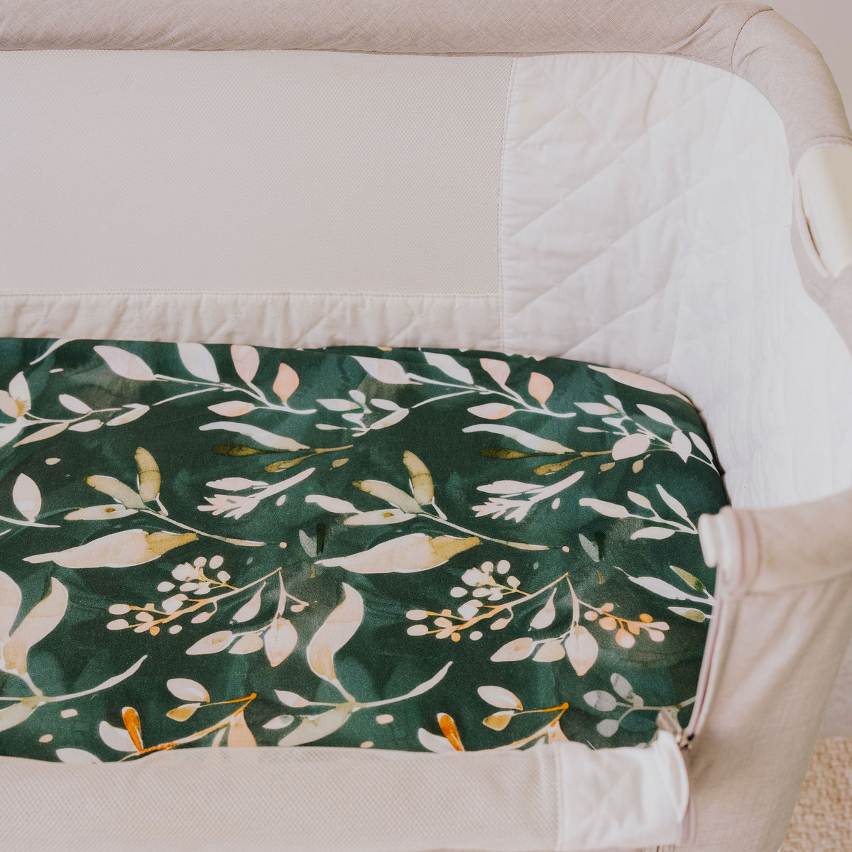 Close-up of the Evergreen waterproof sheet fitted in a bedside co-sleeper