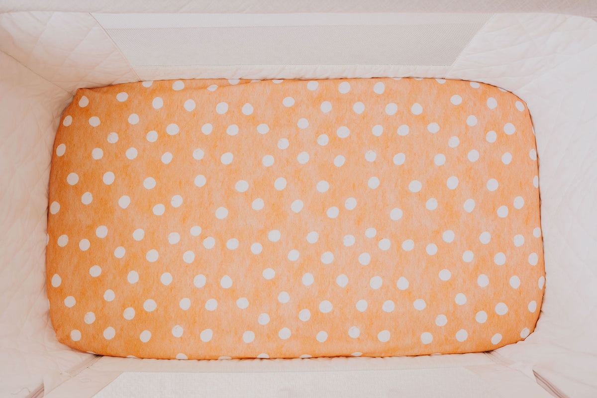 Close-up of the Marmalade waterproof sheet fitted in a bedside co-sleeper