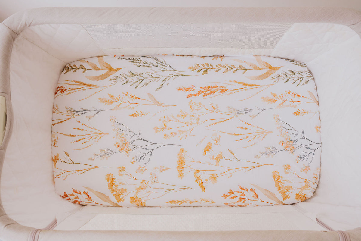 Close-up of the Wild Prairie waterproof sheet fitted in a bedside co-sleeper