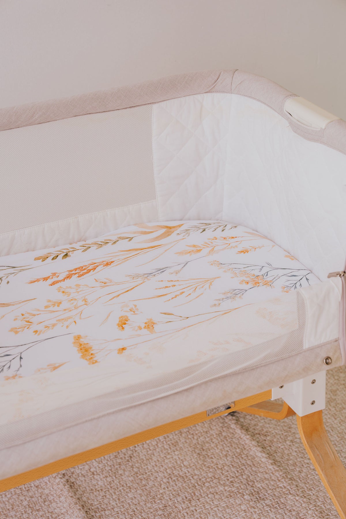 Bedside co-sleeper made up with the Wild Prairie waterproof sheet
