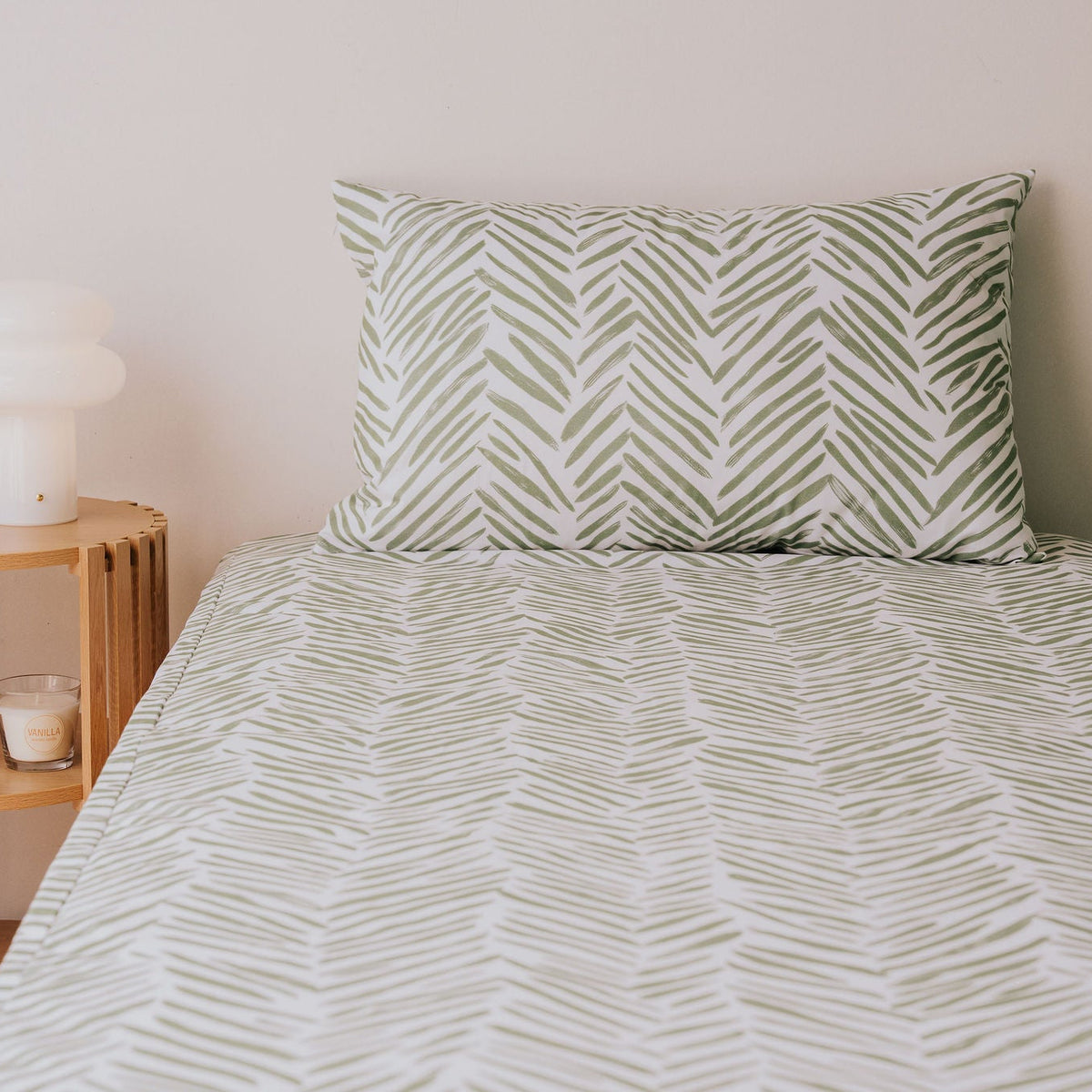 Waterproof pillowcase in Greenhouse print on a single bed with the matching fitted sheet