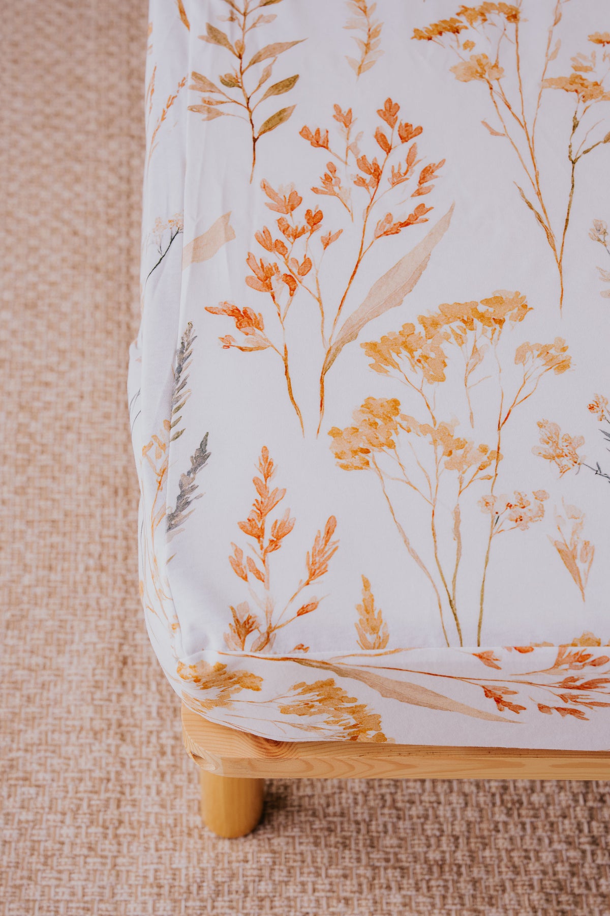 Close-up of the Wild Prairie waterproof fitted sheet hugging the mattress corner