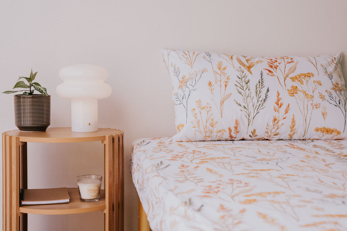 Close view of a bed made up in the Wild Prairie fitted sheet and pillowcase