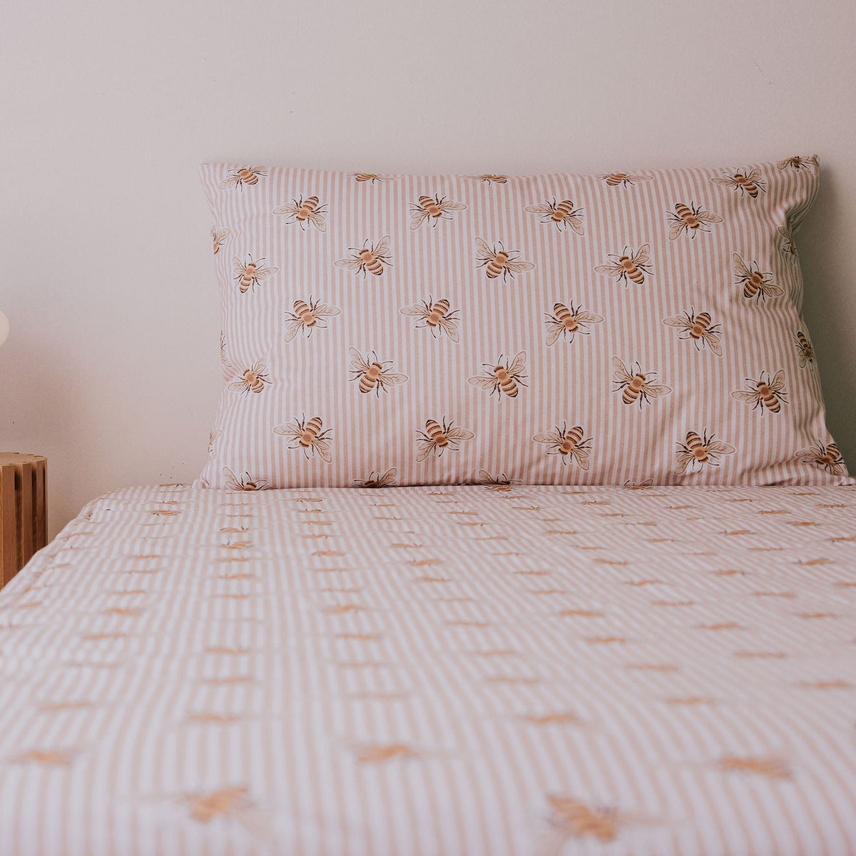 Waterproof pillowcase in Beeline print on a single bed with the matching fitted sheet