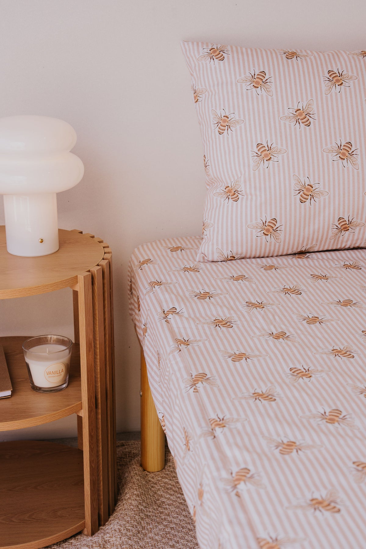 Beeline waterproof fitted sheet and pillowcase on a bed beside a timber side table