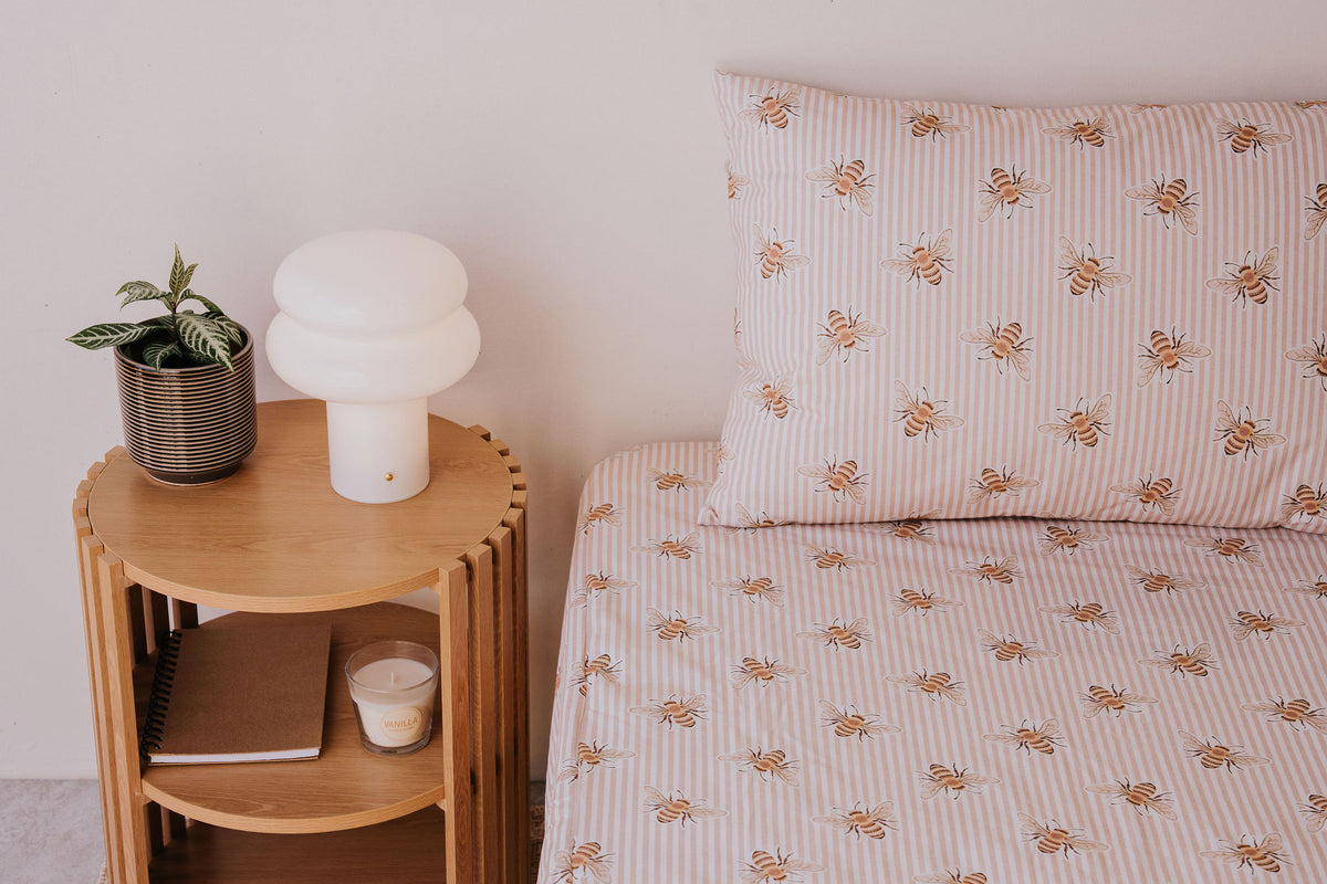 Close view of a bed made up in the Beeline fitted sheet and pillowcase