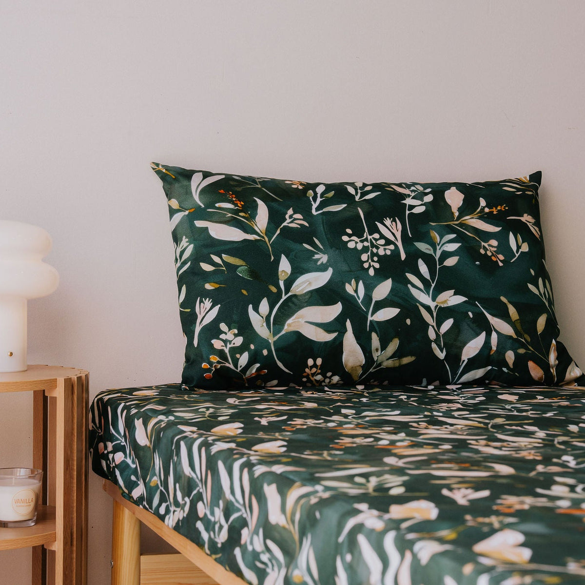 Waterproof pillowcase in Evergreen print on a single bed with the matching fitted sheet