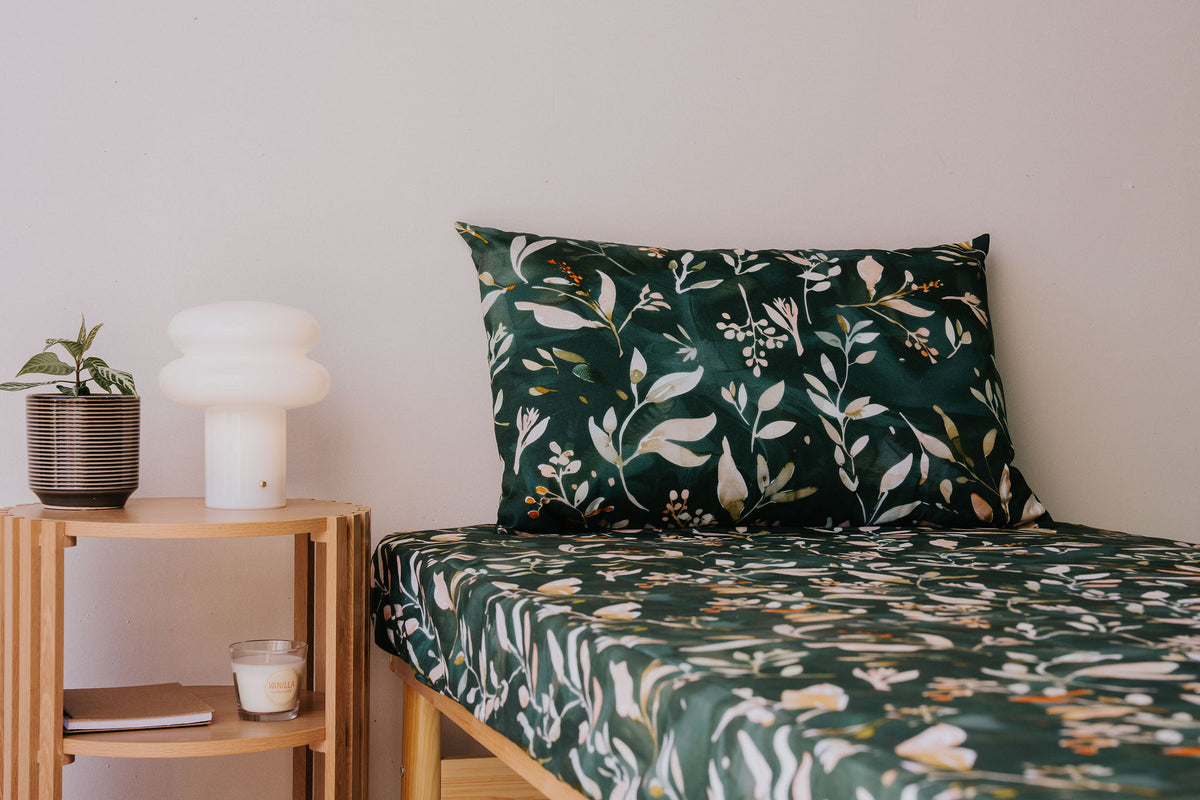 Close view of a bed made up in the Evergreen fitted sheet and pillowcase