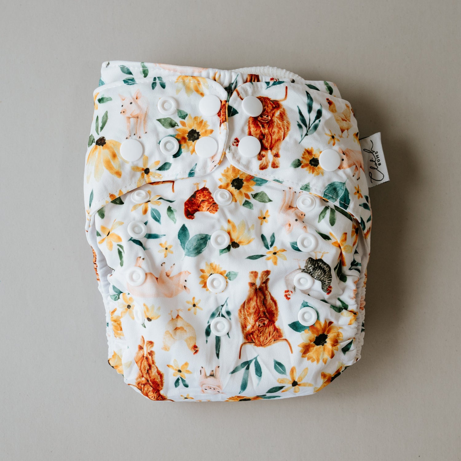 Floral patterned diaper with a tag on a beige background