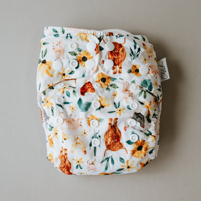 Floral patterned diaper with a tag on a beige background