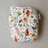 Floral patterned diaper with a tag on a beige background