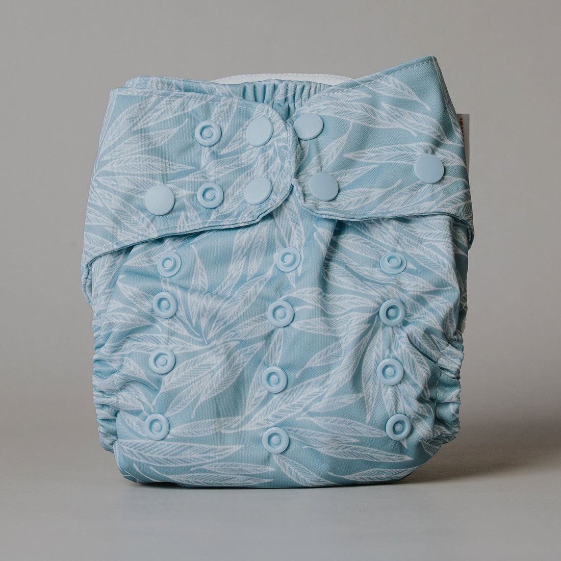 Blue leafy patterned diaper on a gray background