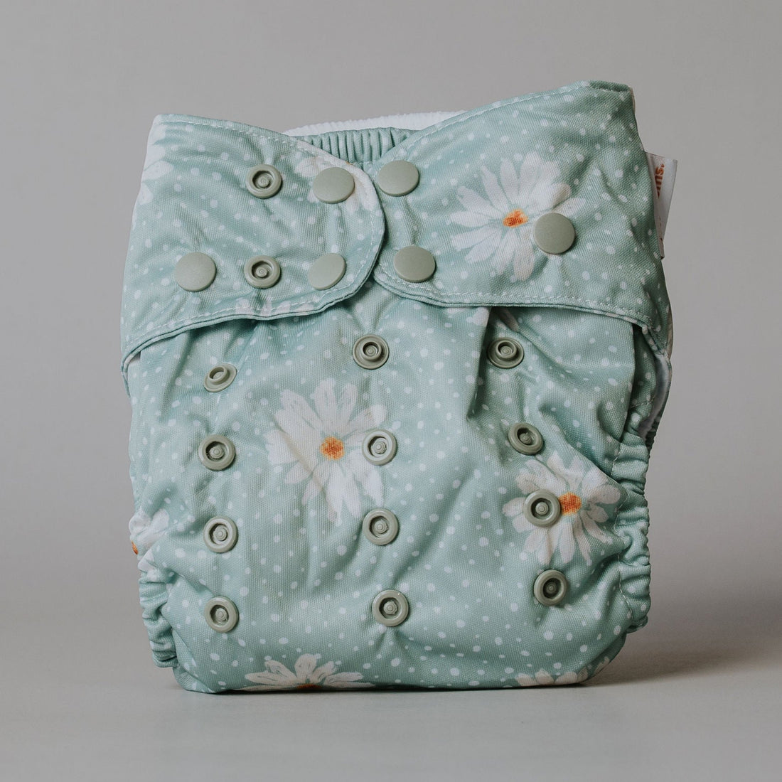 Floral-patterned cloth diaper on a plain background