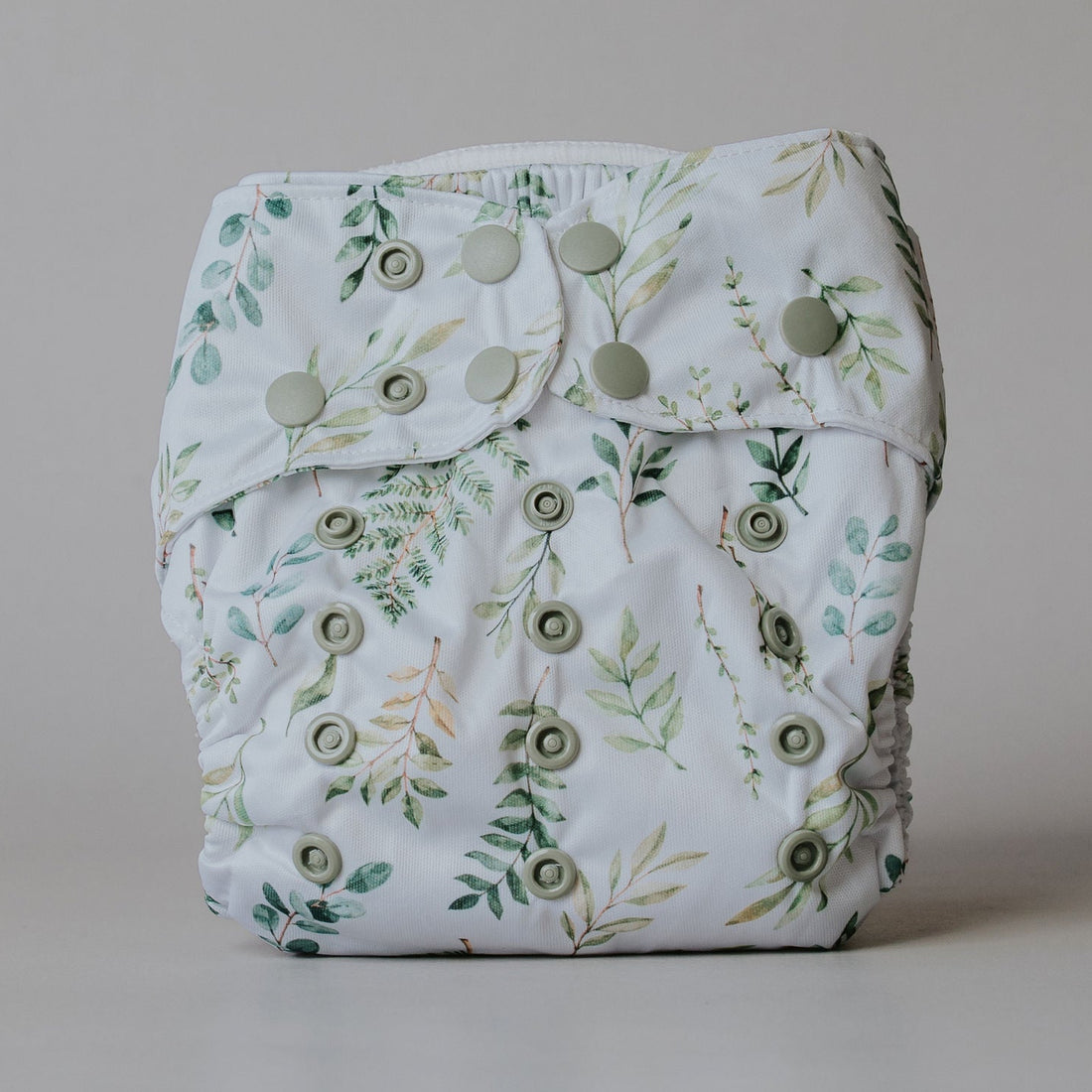 Leafy-patterned diaper on a plain background