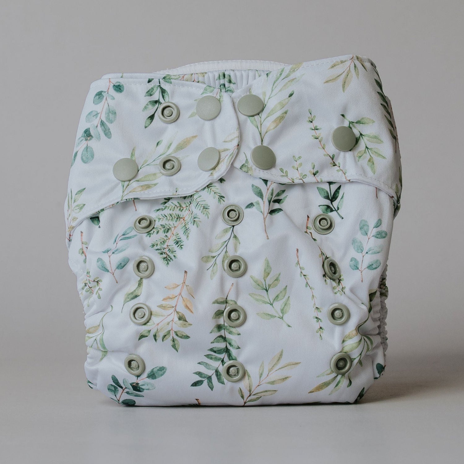 Leafy-patterned diaper on a plain background