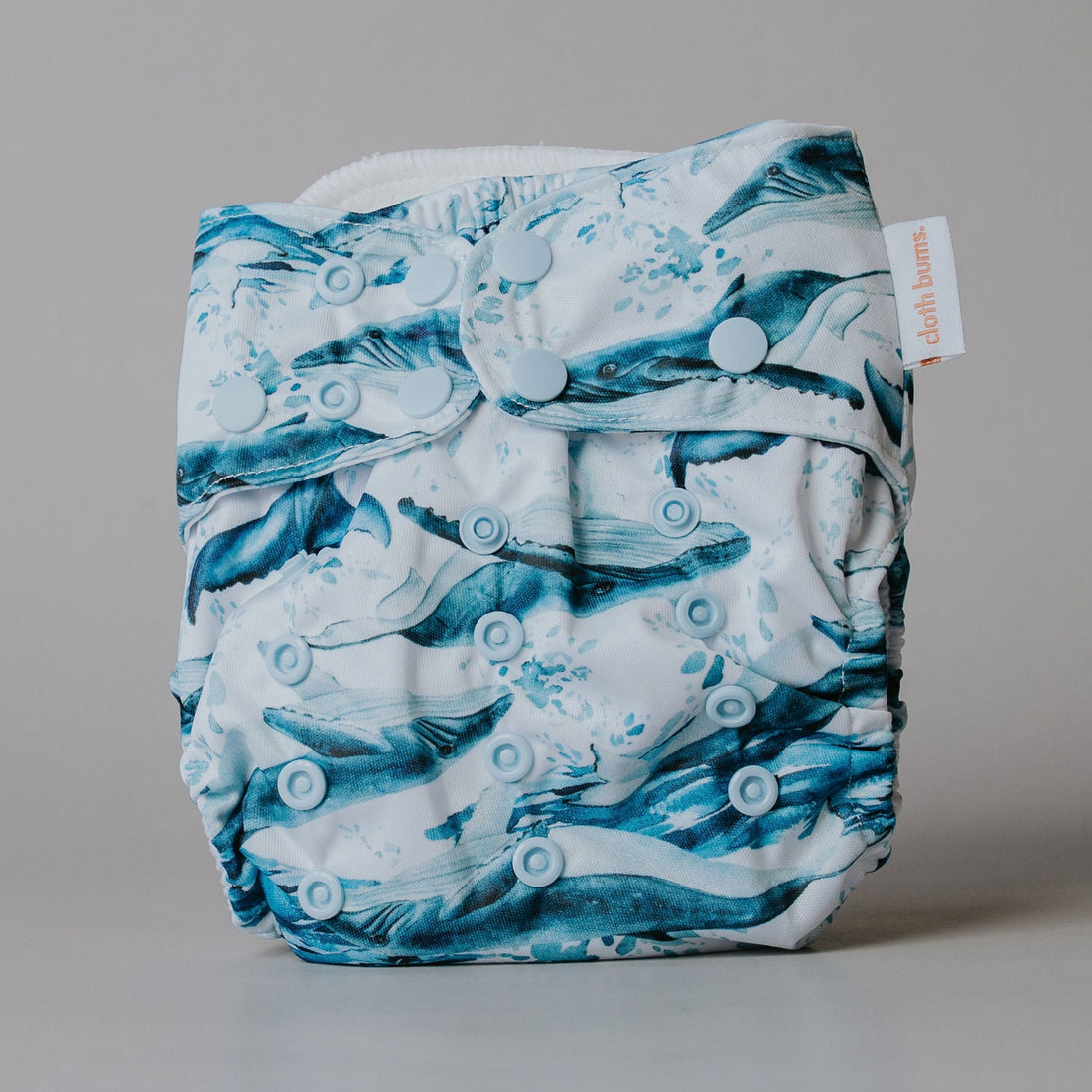Blue and white patterned cloth diaper on a gray background