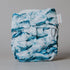 Blue and white patterned cloth diaper on a gray background