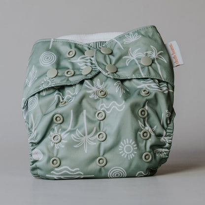 Green patterned cloth diaper on a gray background