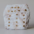 Champagne coloured diaper with gold buttons on a gray background
