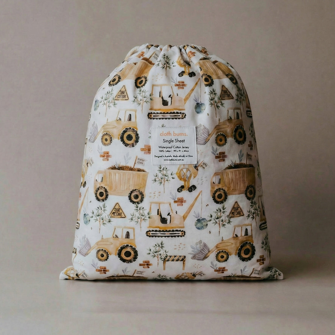 Drawstring bag with digger-themed design on a beige background