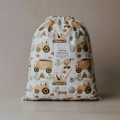 Drawstring bag with digger-themed design on a beige background