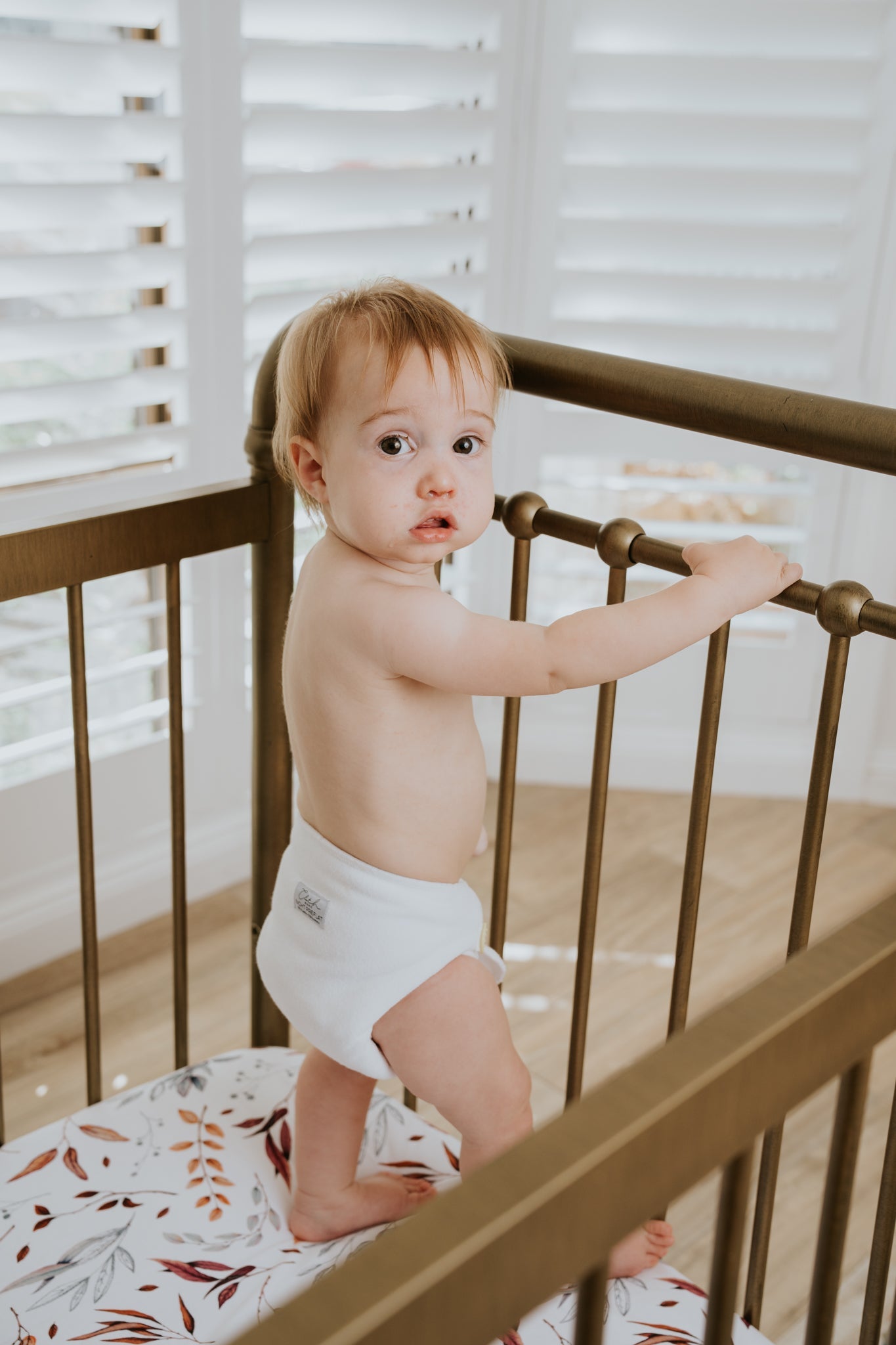 Baby boy wearing a white preflat nighttime nappy