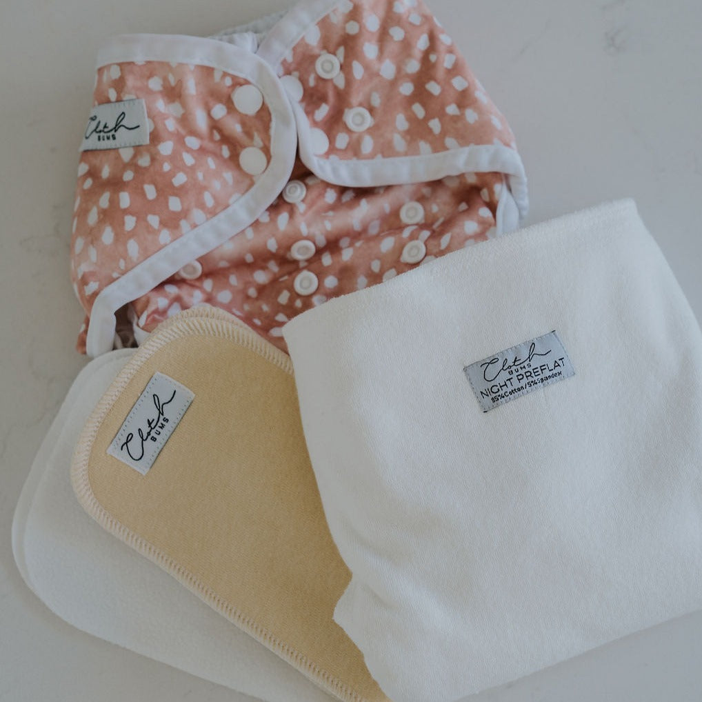 Image of modern cloth nappies including a preflat and waterproof cover